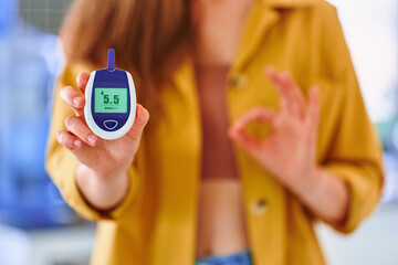 Female using glucose meter for measuring and monitoring blood level. Healthcare and mellitus...