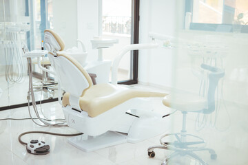 Modern dental practice. Dental chair and other accessories used by dentists. Dentist Office, Dental Hygiene, Dentist's Chair. dentistry, medicine, medical equipment and stomatology concept