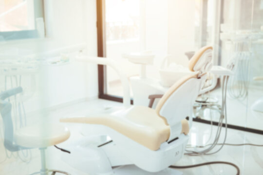 Defocused background and copy space image of dental office with dentist chair and equipment. Dental chair and equipment. Patient reception room in a modern medical center.
