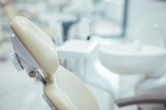 A clean modern well equipped dental surgery prepped and ready to take the first patient of the day . Horizontal color image of modern dental office with equipment.
