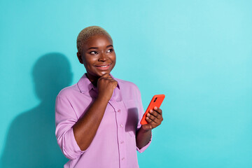 Photo of minded blogger girl hand touch chin look interested empty space wonder isolated on teal...