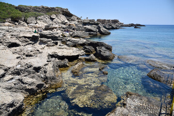 Kalithea beach in Rhodes, Greece. Clean water of Mediterranean Sea and rocks.