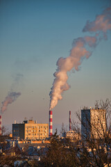 Warsaw, Poland - 01.23.2022: chimney blowing smoke, factory in Warsaw