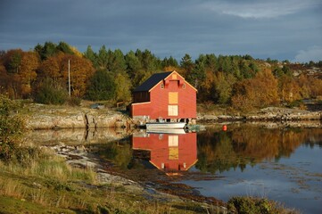 Coastal boathouse in Norway in autumn.