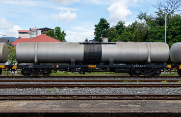 The bogie of the oil tanker in the freight train is parking in the railway yard.