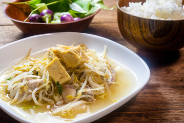 Stir fry bean sprouts with tofu on a wooden table. Healthy menu.