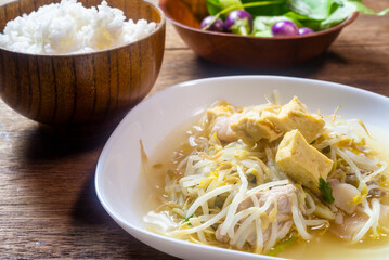 Stir fry bean sprouts with tofu on a wooden table. Healthy menu.
