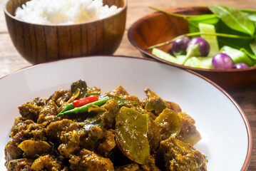 Stir-fried spicy duck curry paste on a wooden table. Ready to eat.