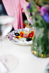 Greek salad is eaten with cutlery