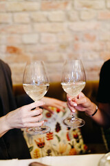 two people drink white wine