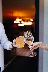 people with a glass of white wine and a cocktail
