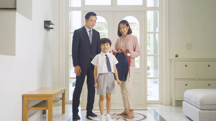 Portrait of happy smiling Asian Family. A student prepaing to go to school at home or house  in family relationship. Love of father, mother, and son. People lifestyle.