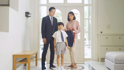 Obraz premium Portrait of happy smiling Asian Family. A student prepaing to go to school at home or house in family relationship. Love of father, mother, and son. People lifestyle.