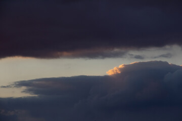 Beautiful dark cloudy sky.
Dark clouds in the sky with sunset light.