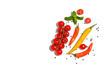 Cooking background with tomato cherry, colored peppers chili and spices isolated on white background