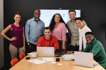Portrait of smiling multiracial businessmen and businesswomen in board room at office
