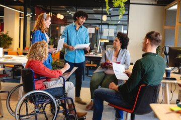 Multiracial businesswomen and businesswomen discussing strategy in meeting at office