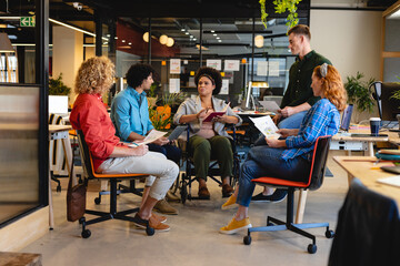 African american businesswoman with disability discussing business plan to colleagues during meeting