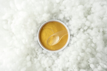 Golden antiaging eye patches with the snail extract lying on a white background