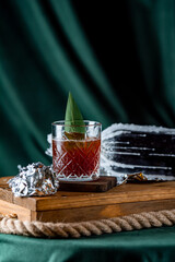 red glass on a piece of wood with foil