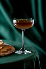 brown cocktail stands on the edge of the table
