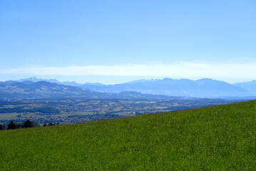 Obraz premium Scenic rural landscape at Forch Küsnacht with mountain panorama in the background on a sunny summer day. Photo taken June 12th, 2022, Forch Küsnacht, Switzerland.