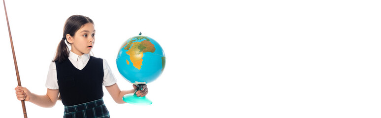 Fototapeta premium Amazed schoolchild holding pointer and looking at globe isolated on white, banner.