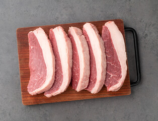 Sliced raw picanha or rump meat over wooden board