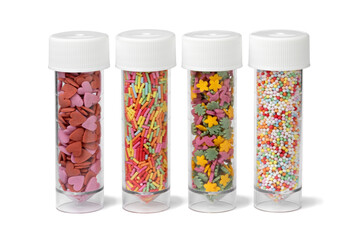 Plastic tubes with colorful sugar sprinkles to decorate homemade pastry isolated on white...
