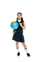 Full length of preteen schoolkid holding pencil and globe on white background.