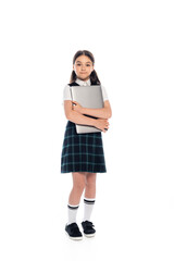 Smiling schoolkid hugging laptop and looking at camera on white background.