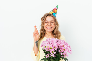 Cheerful young woman in party cap