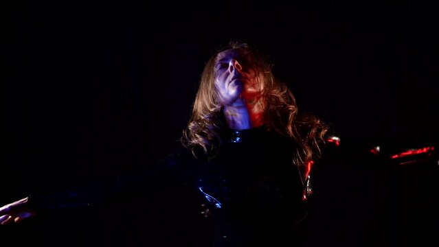 Trans dance slender figure of a woman dressed in a black latex suit