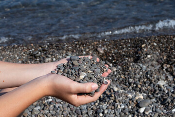 boy holds stones in his hands