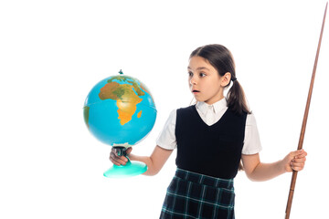 Shocked schoolgirl holding pointer and looking at globe isolated on white.