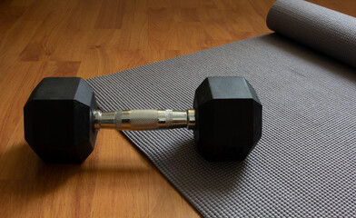 dumbbell on floor with yoga mat , home fitness wellnessand good health concept