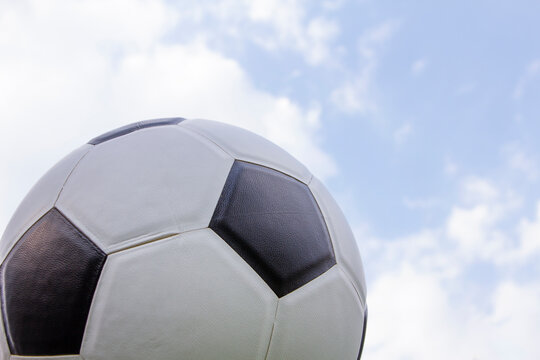 shoot the ball on the air with blue sky , football or soccer sport