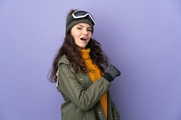 Teenager Russian girl with snowboarding glasses isolated on purple background proud and self-satisfied