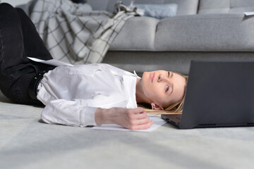 Woman lies on floor resting during work break