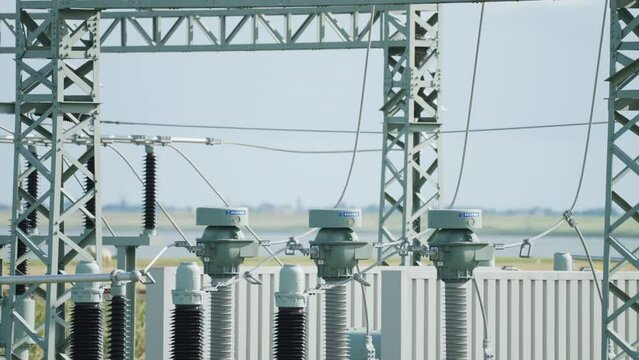 A close-up shot of an electrical power plant. Slow-motion, pan right