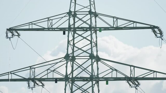 A close-up shot of the electrical power lines. Slow-motion, pan right