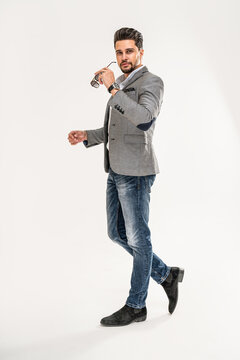 Full length photo of handsome man wearing jeans, shirt, elegant jacket and sunglasses. Men's beauty, fashion.