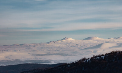 Mountains in the snow. 
Winter mountains view covered with snow.