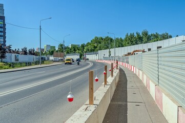 A road and a sidewalk marked with red lanterns