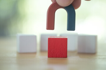 The magnet attracting red wood block