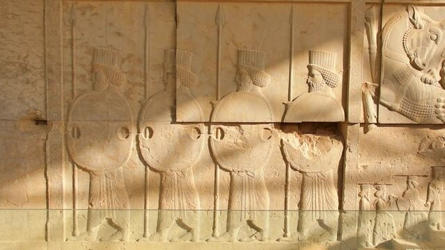 Carved stones with persian soldiers in famous Persepolis archeological site