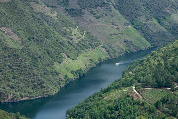 Boat sailing through the canyon of the river Sil. Unesco World Heritage of Humanity. Ribeira Sacra....