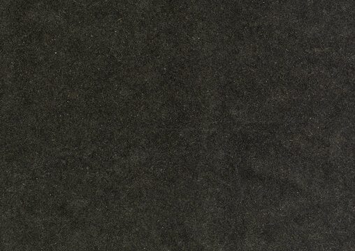 High resolution highly detailed large image of an paperboard carton uncoated paper texture background black with large rough grain fiber and white dust particles wallpaper with copy space for text