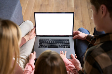 Happy family parents and kid child daughter using laptop computer mock up white screen sitting on...