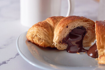 Yummy freshly croissant, sliced almonds, with chocolate filling